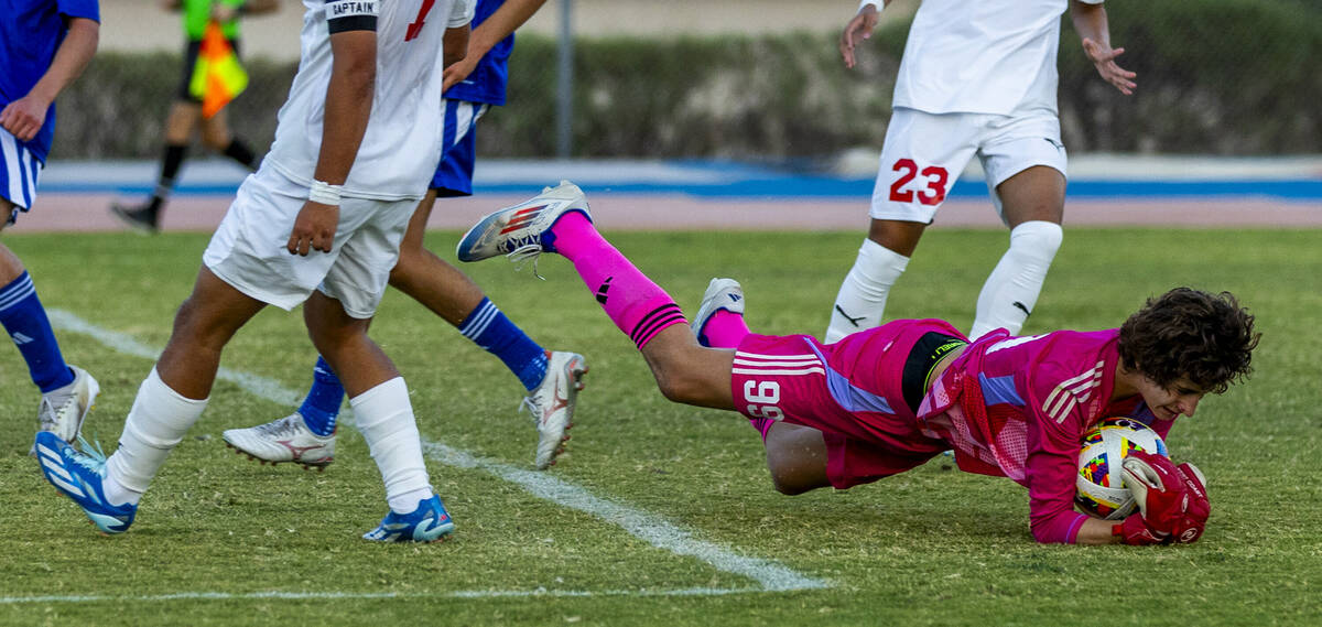 Bishop Gorman goalkeeper Chase Cosenza (99) dives on a shot attempt by Coronado during the seco ...