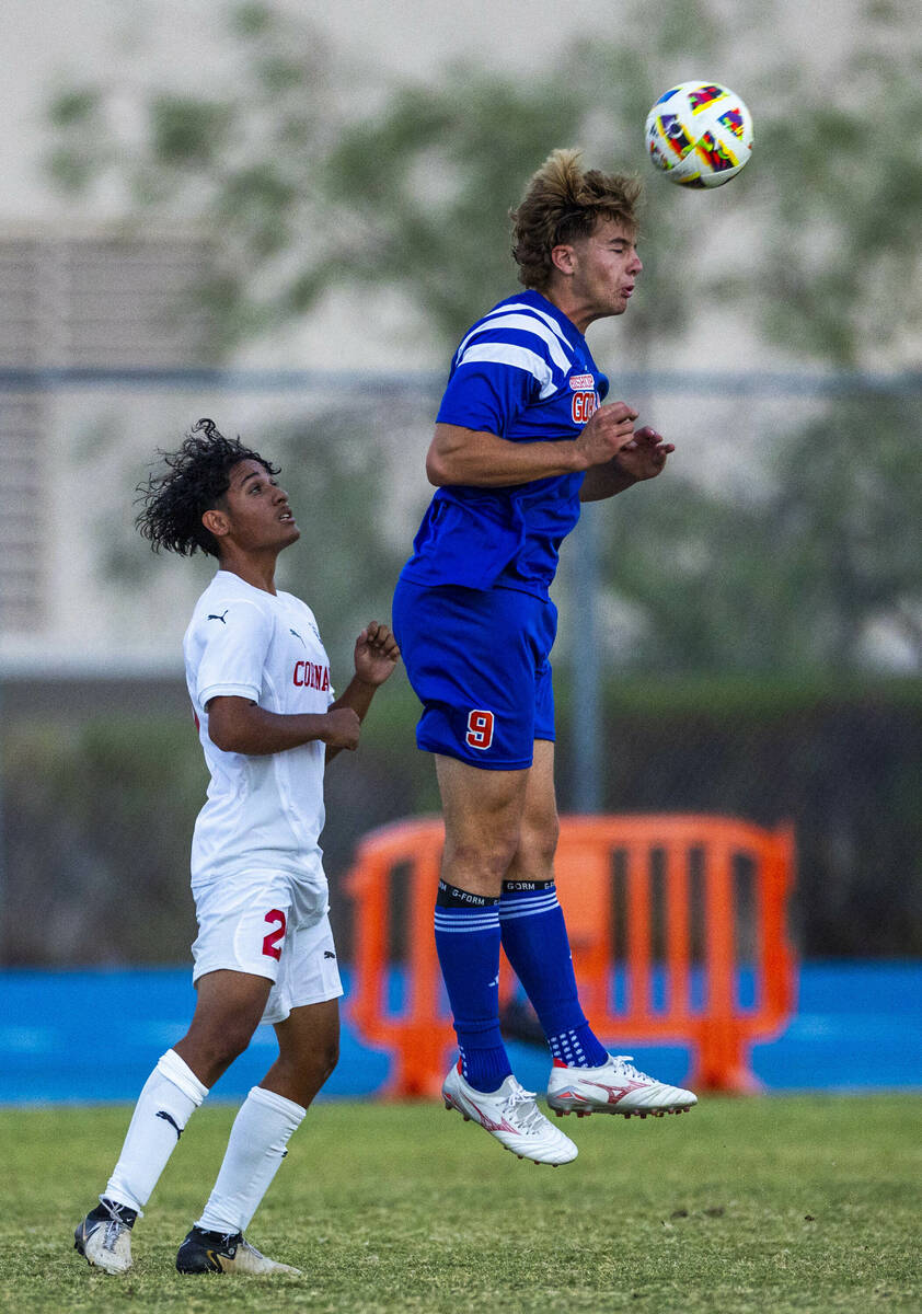 Bishop Gorman forward Chase Stewart (9) heads the ball away from Coronado midfielder Brody Bree ...