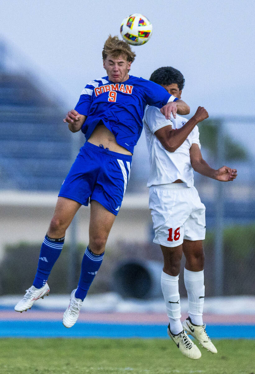 Bishop Gorman forward Chase Stewart (9) heads the ball away from Coronado midfielder Josh Pined ...