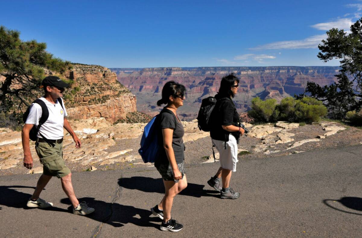 From left; Ivan Oggioni, Barbara Negro, and Barbara Arcobelli from Italy, walk along the Rim Tr ...