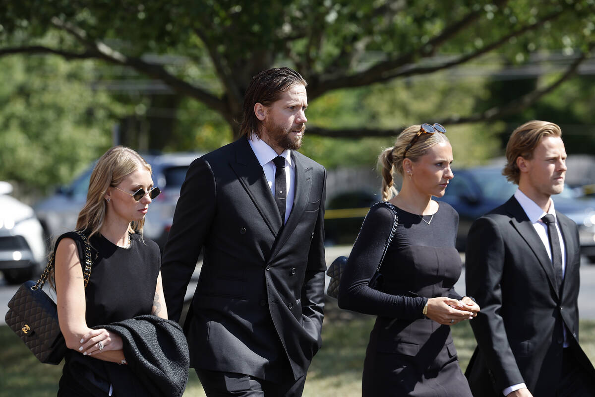 New Jersey Devils goaltender Jacob Markström, second left, arrives for the funeral service ...