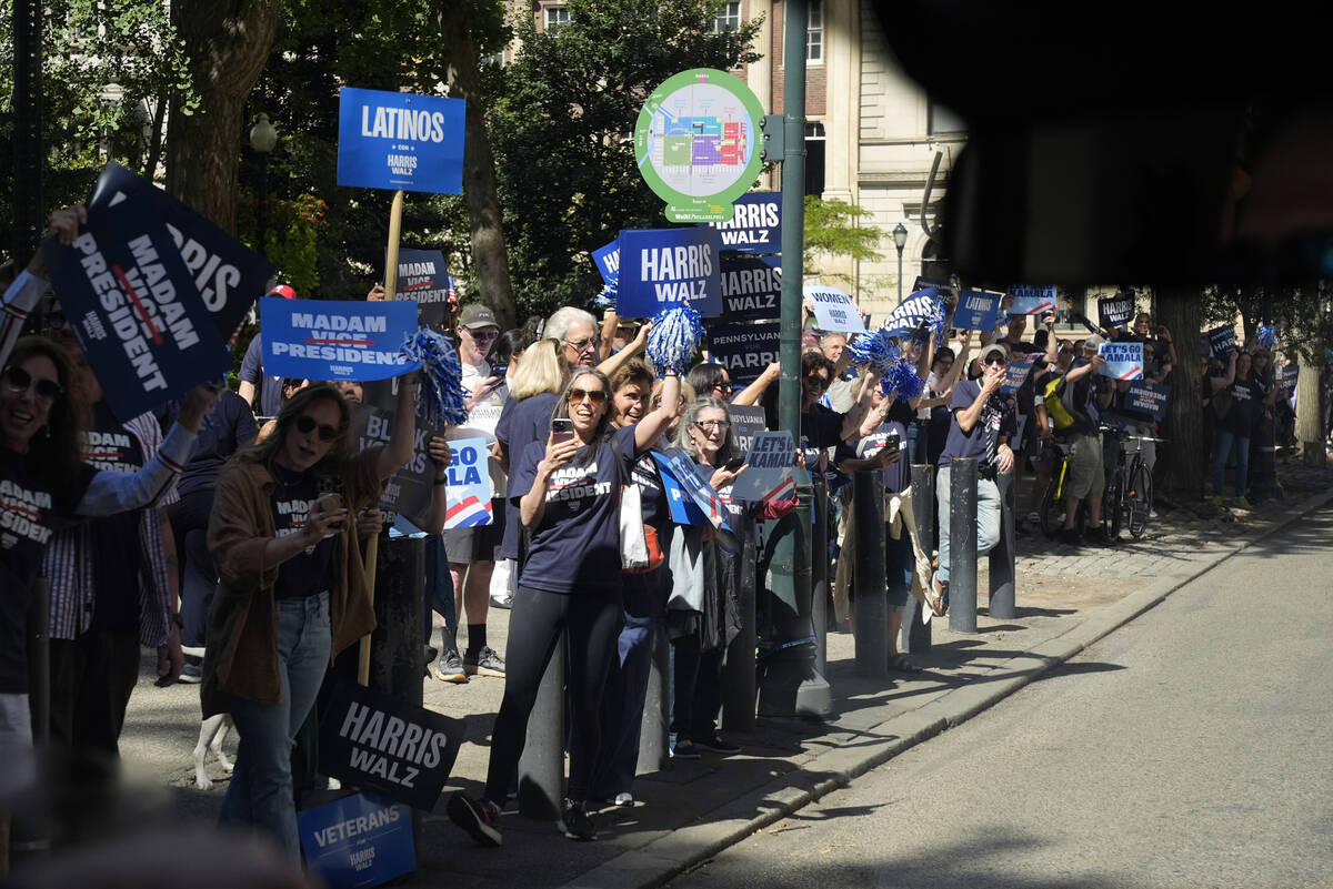 People line the sidewalk as the motorcade carrying Democratic presidential nominee Vice Preside ...