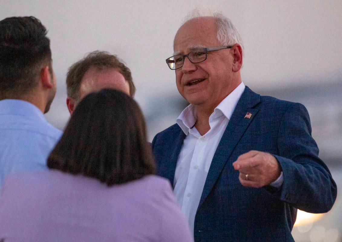 Democratic vice presidential candidate Minnesota Gov. Tim Walz, right, greets local politicians ...