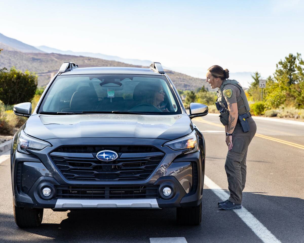 In a provided photo, an officer with the Washoe County Sheriff's Office directs a woman away fr ...