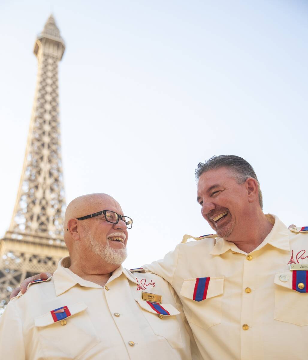 Mike Grenier, left, and James Ealey, right, both Paris Las Vegas day-one employees, laugh outsi ...