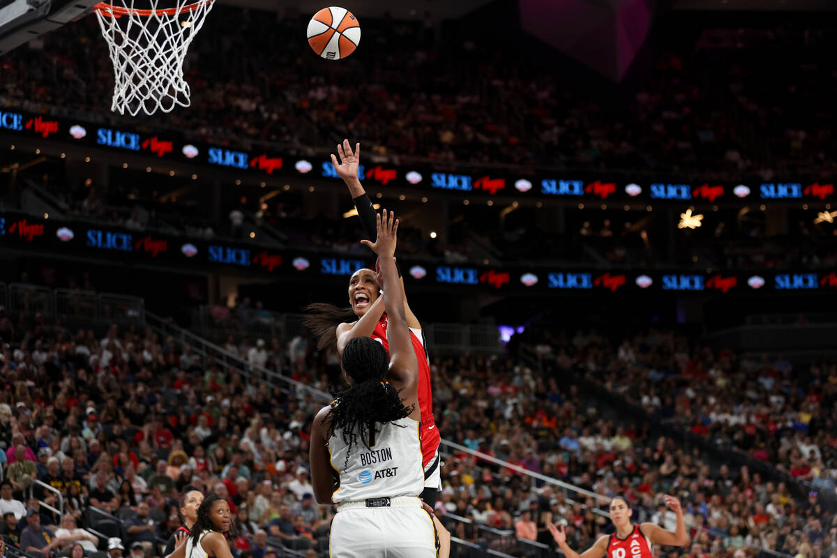 Las Vegas Aces center A'ja Wilson (22) shoots over Indiana Fever forward Aliyah Boston (7) duri ...