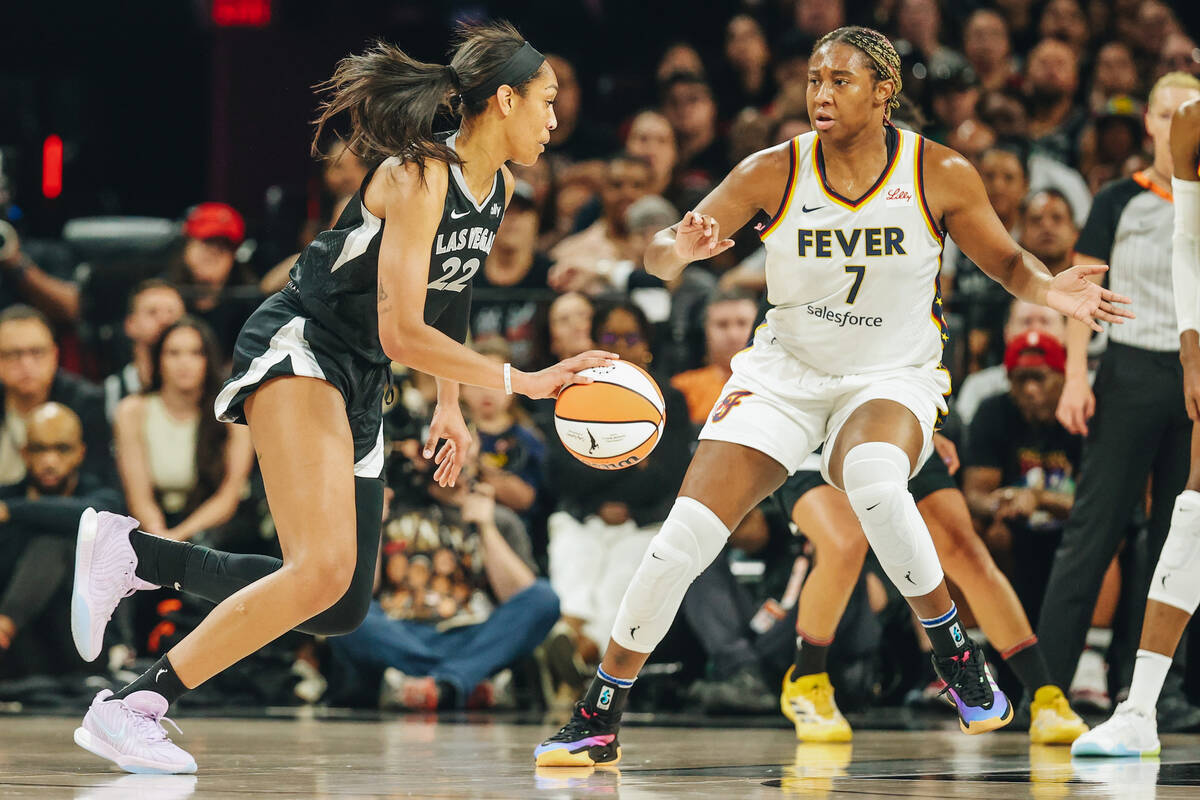 Aces center A'ja Wilson (22) dribbles the ball past Indiana Fever forward Aliyah Boston (7) dur ...