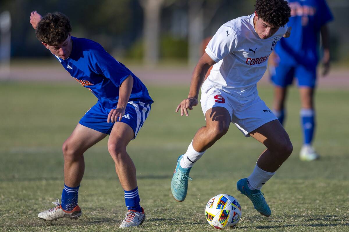 Bishop Gorman midfielder Rockwell Rabago (8) looks on as Coronado striker Dylan Flores (9) stea ...