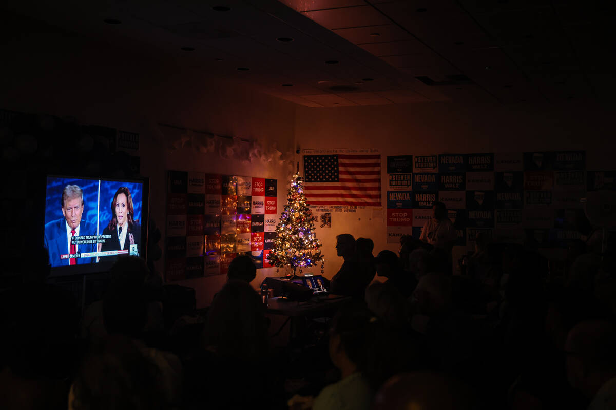 Attendees watch the presidential debate between Kamala Harris and Donald Trump at the Harris-Wa ...