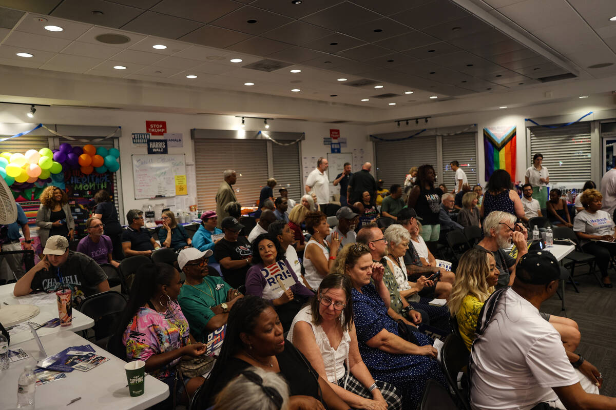 Attendees wait during a commercial break at a watch party for the presidential debate between K ...