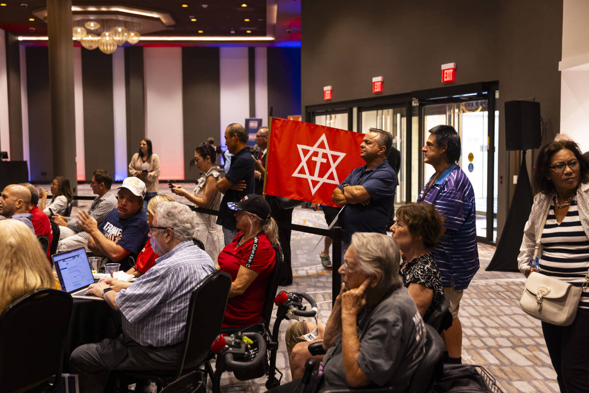 Supporters of Republican presidential nominee former President Donald Trump watch a a televised ...