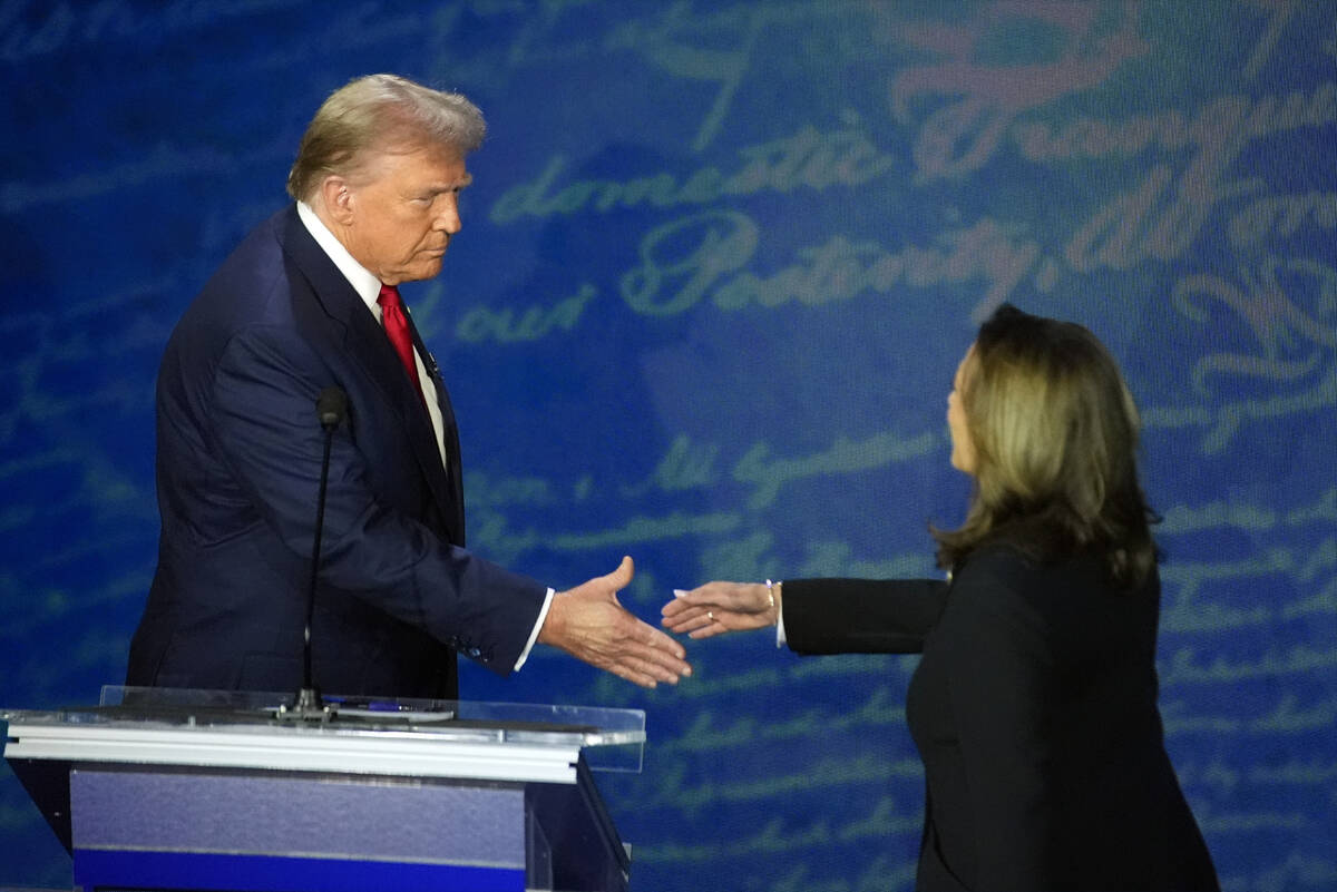 Republican presidential nominee former President Donald Trump shakes hands with Democratic pres ...