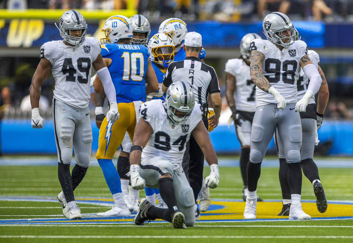 Raiders defensive tackle Christian Wilkins (94), defensive end Maxx Crosby (98) and defensive e ...