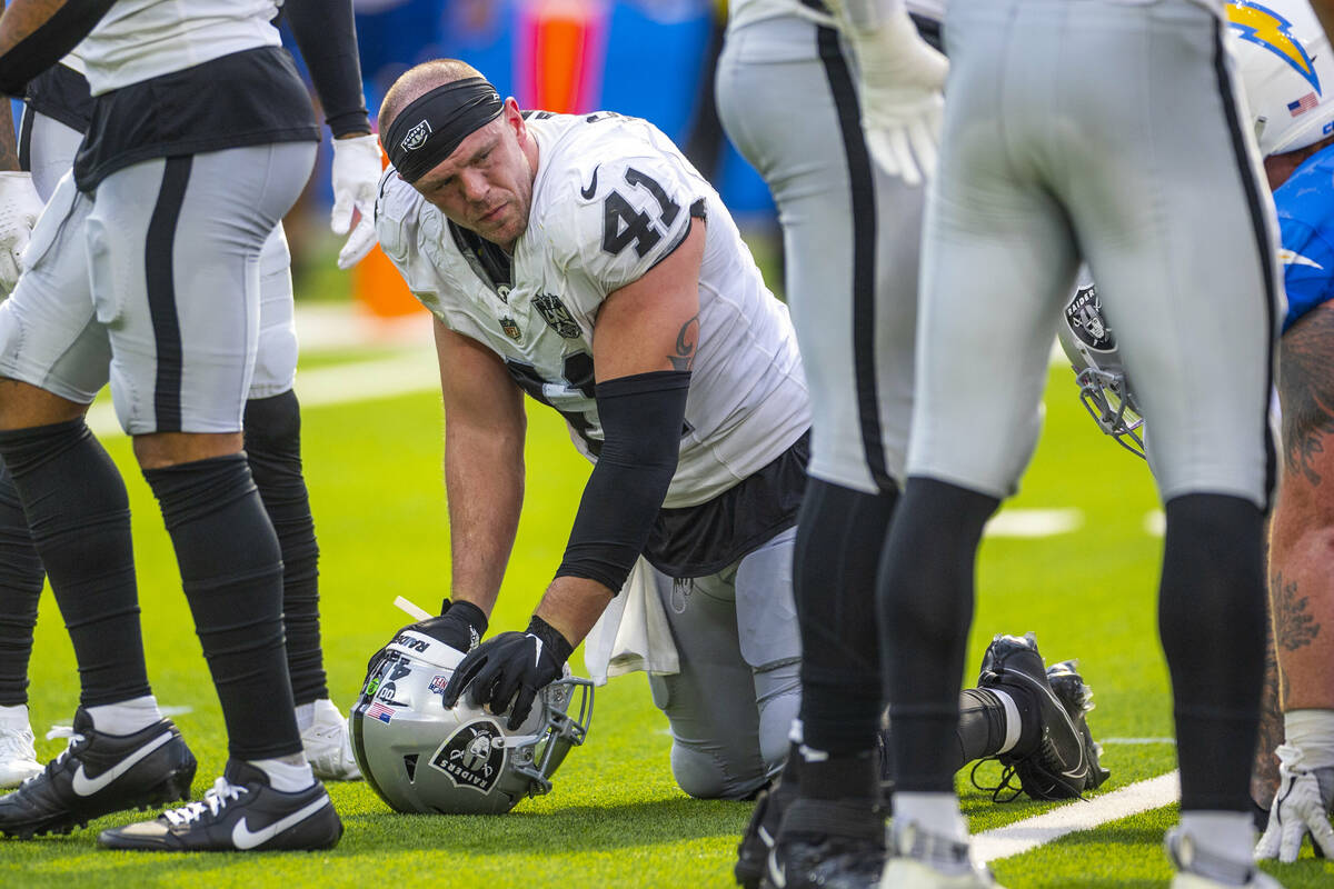 Raiders linebacker Robert Spillane (41) is spent on the field as the game nears and end against ...