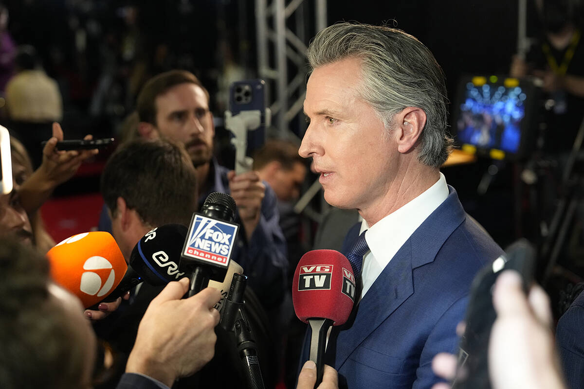 California Gov. Gavin Newsom speaks to reporters in the spin room after a presidential debate b ...