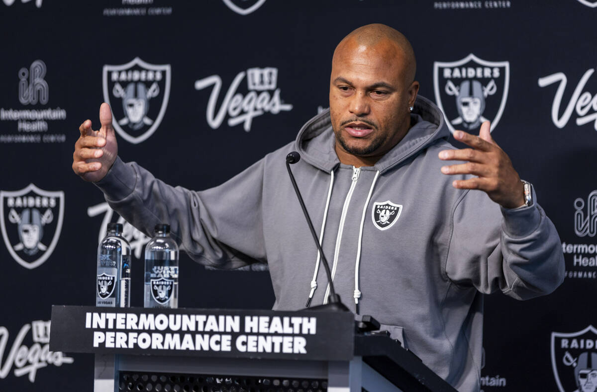 Raiders head coach Antonio Pierce answers a question during a media interview before practice a ...