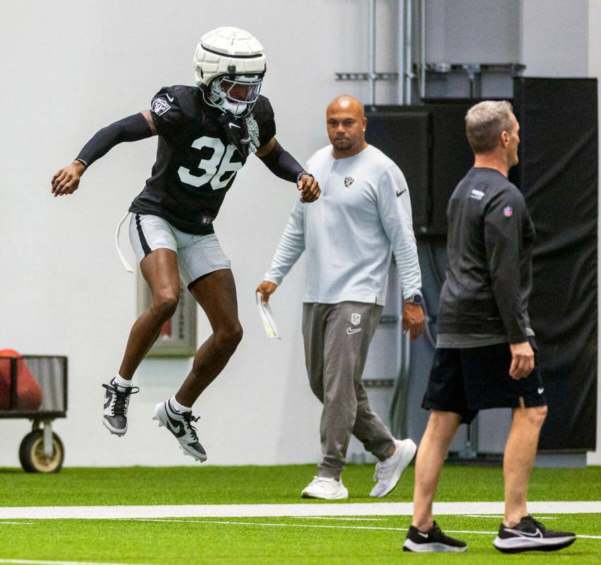 Raiders cornerback Kyu Blu Kelly (36) jumps in warm ups as head coach Antonio Pierce walks pas ...