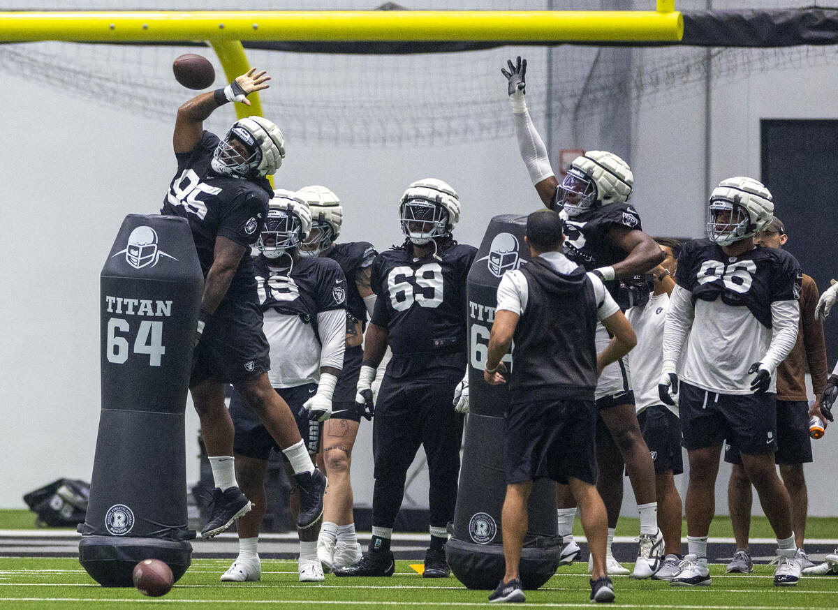 Raiders defensive tackle John Jenkins (95) attempts to swat down a ball during practice at the ...