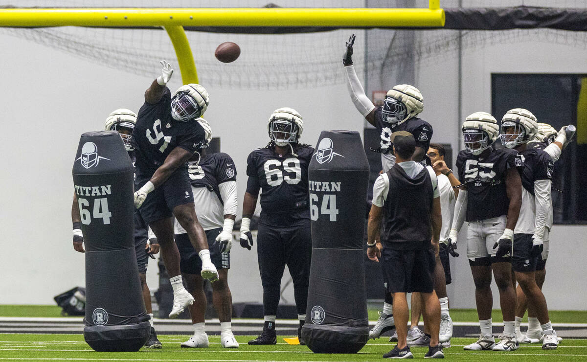 Raiders defensive tackle Matthew Butler (91) attempts to swat down a ball during practice at th ...