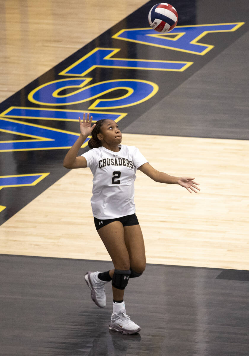 Faith Lutheran junior K Sawyer (2) serves the ball during the high school volleyball game again ...