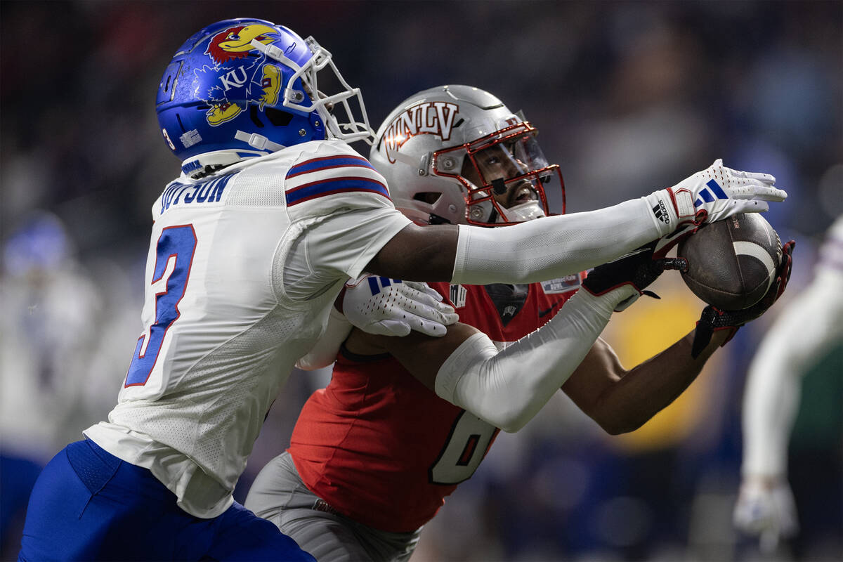 Kansas Jayhawks cornerback Mello Dotson (3) breaks up a pass intended for UNLV Rebels wide rece ...