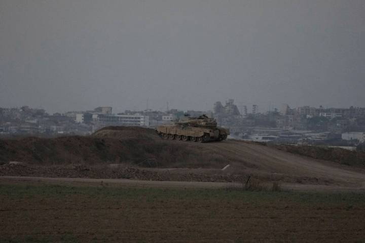 An Israeli tank overlooks the Gaza Strip, as seen from southern Israel, Wednesday, Sept. 11, 20 ...