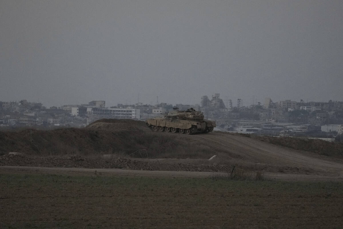 An Israeli tank overlooks the Gaza Strip, as seen from southern Israel, Wednesday, Sept. 11, 20 ...