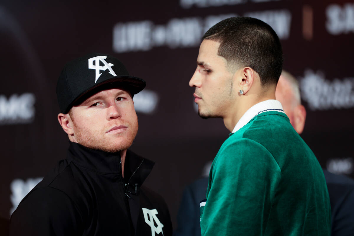 Canelo Alvarez, left, turns away after facing off with Edgar Berlanga during press conference a ...