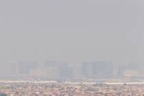 Strong winds blow in smoke from wildfires across the west coast, shrouding the city in a haze, ...