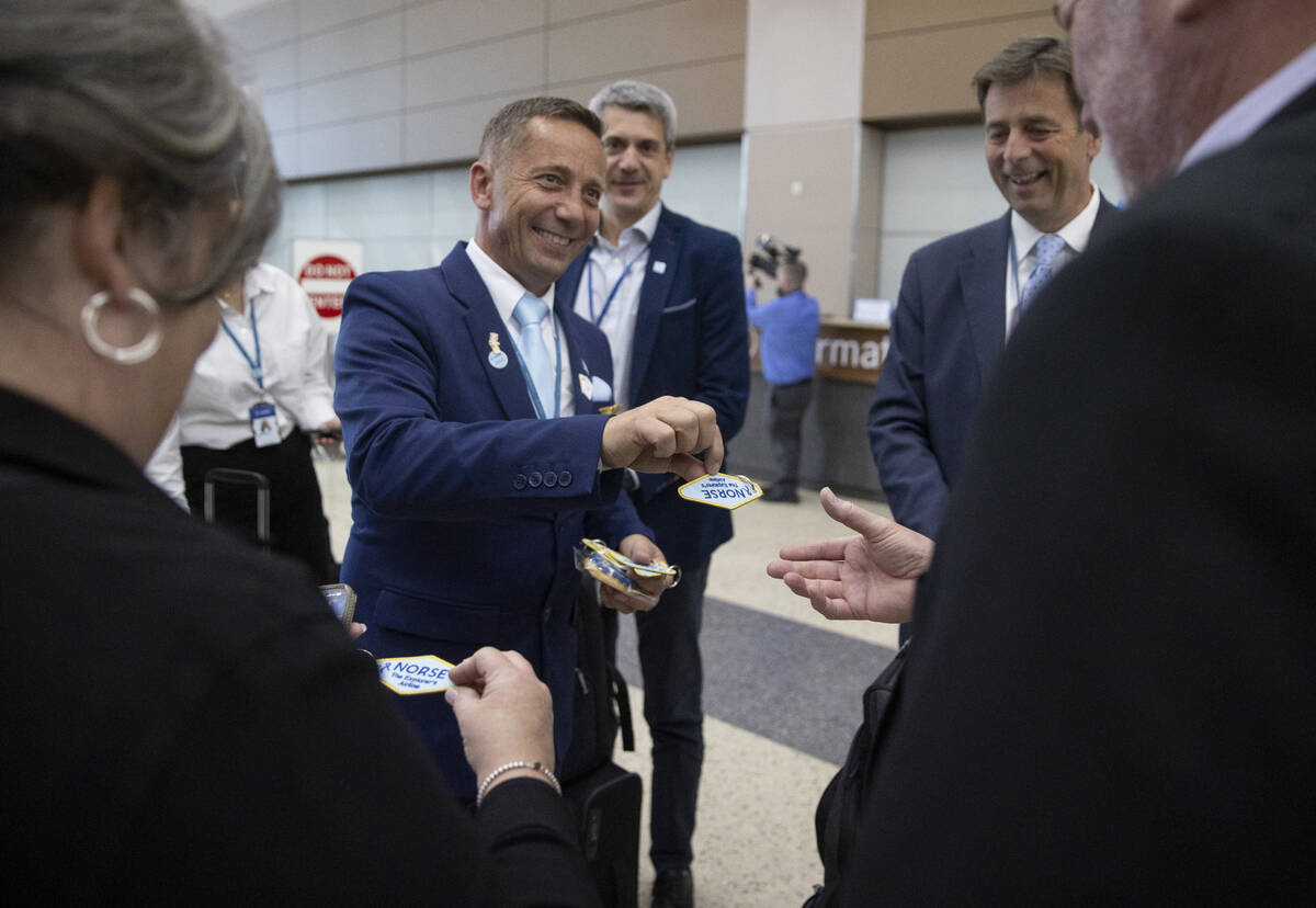 Norse Atlantic Airways staff hand out keychains and pins during the celebration of airways&#x20 ...