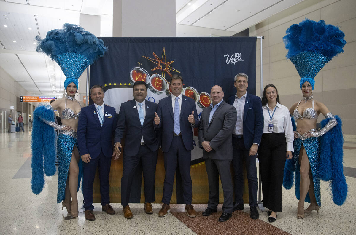 Norse Atlantic Airways staff take photographs with showgirls during the celebration of the airw ...