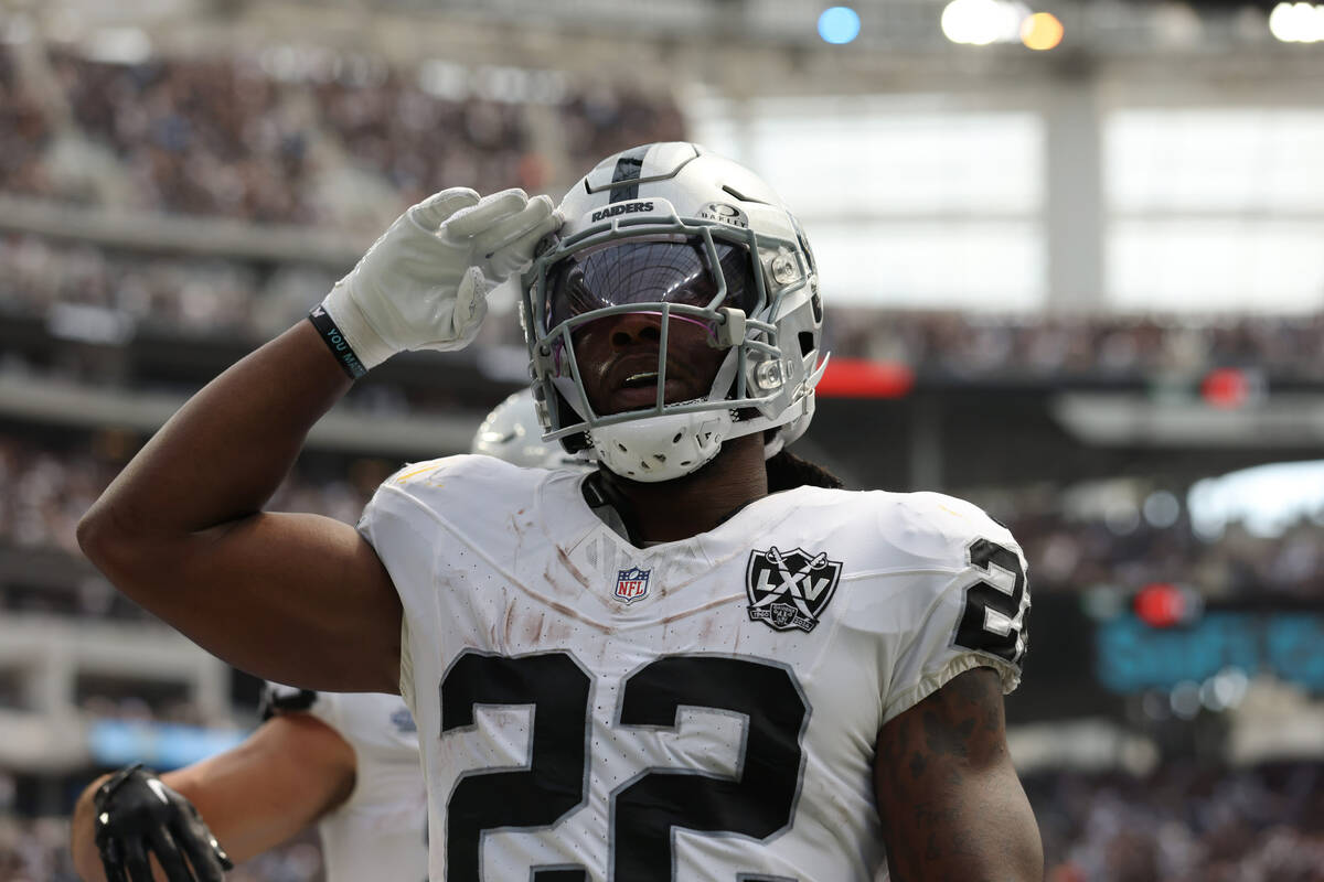 Raiders running back Alexander Mattison (22) salutes after scoring a touchdown during the first ...