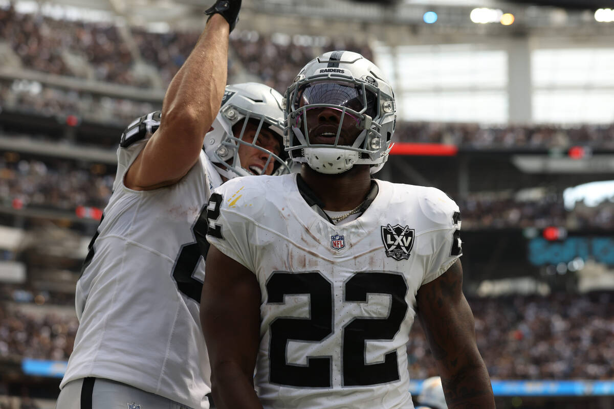 Raiders tight end Brock Bowers (89) celebrates with running back Alexander Mattison (22) after ...