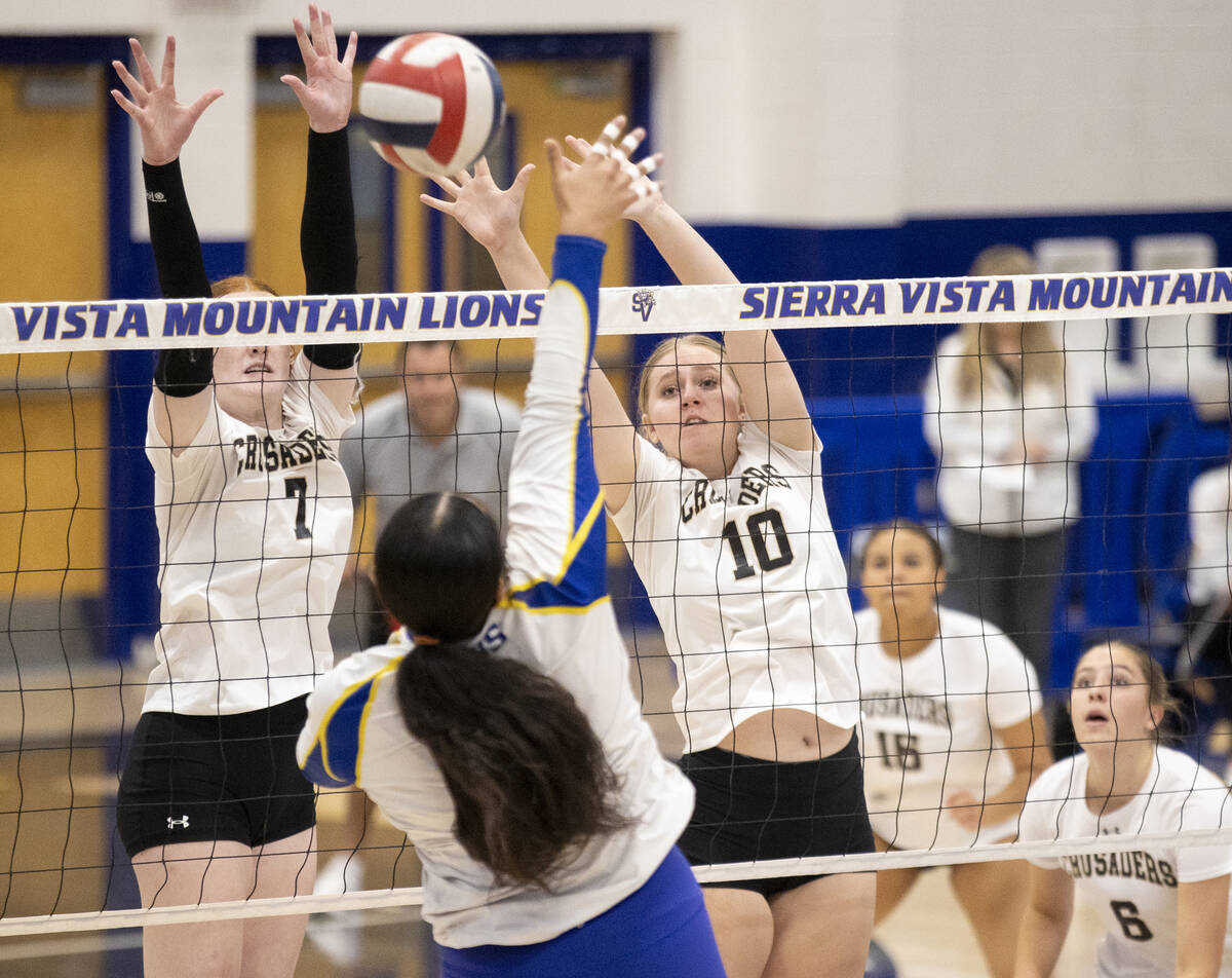 Faith Lutheran junior Parker LaFontaine (7) and sophomore Abby Keyes (10) attempt to block a sp ...