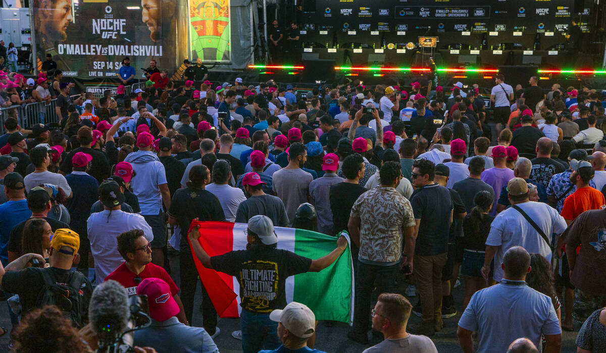 A fan holds a Mexican flag UFC 306 press conference at the Sphere on Thursday, Sept. 12, 2024, ...