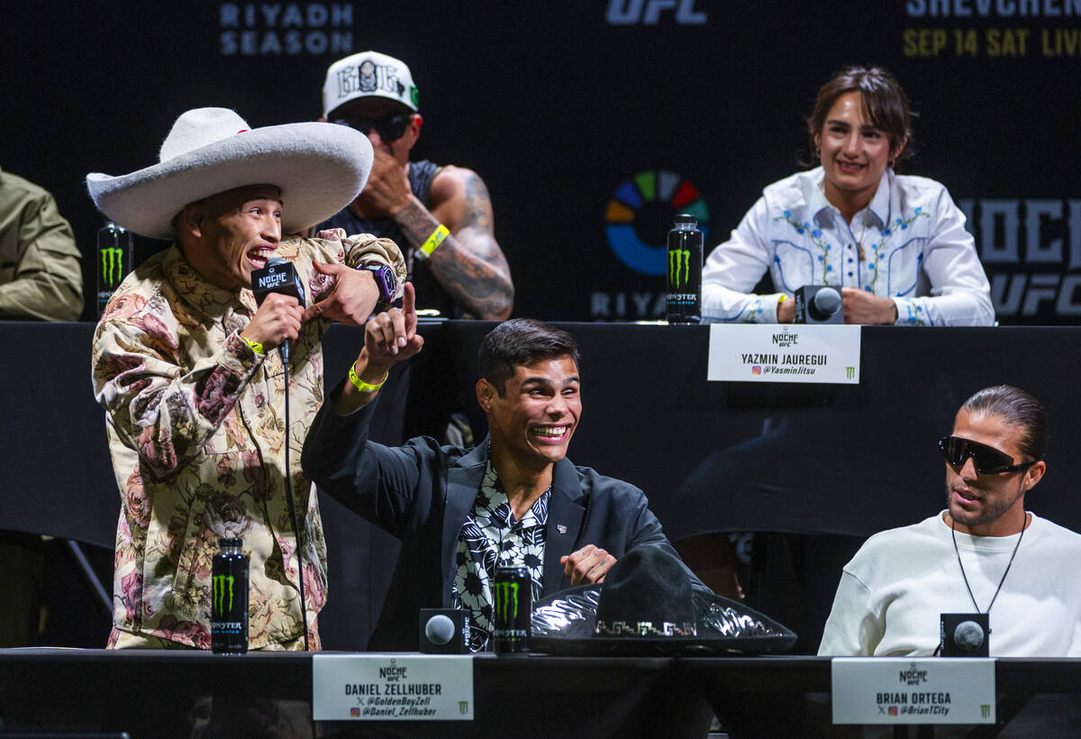 Fighters Ronaldo Rodriguez, left, talks about his opponent as Daniel Zellhuber reacts during th ...