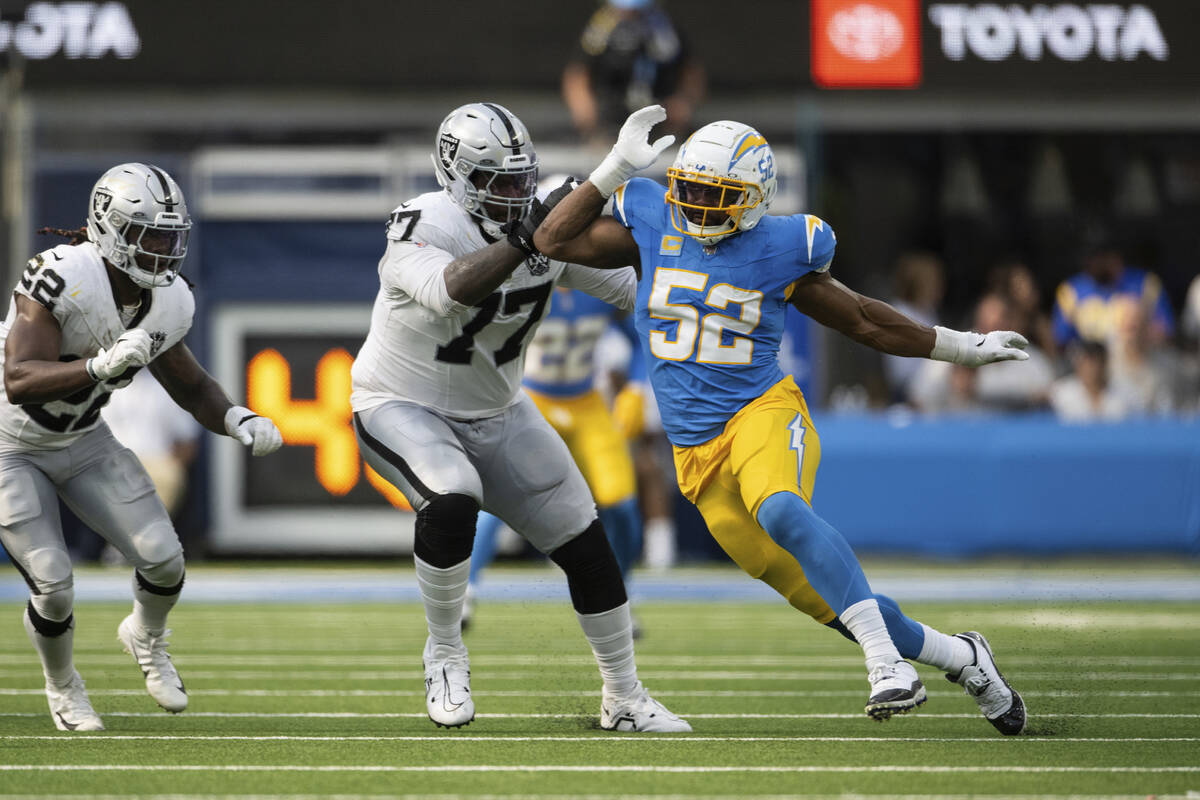 Los Angeles Chargers linebacker Khalil Mack (52) runs past Las Vegas Raiders offensive tackle T ...