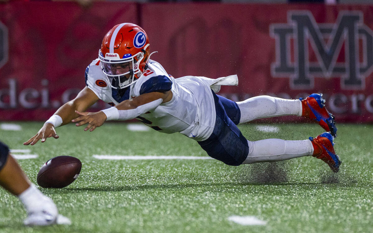 Bishop Gorman quarterback Melvin Spicer IV (2) dives to a fumbled ball against Mater Dei during ...