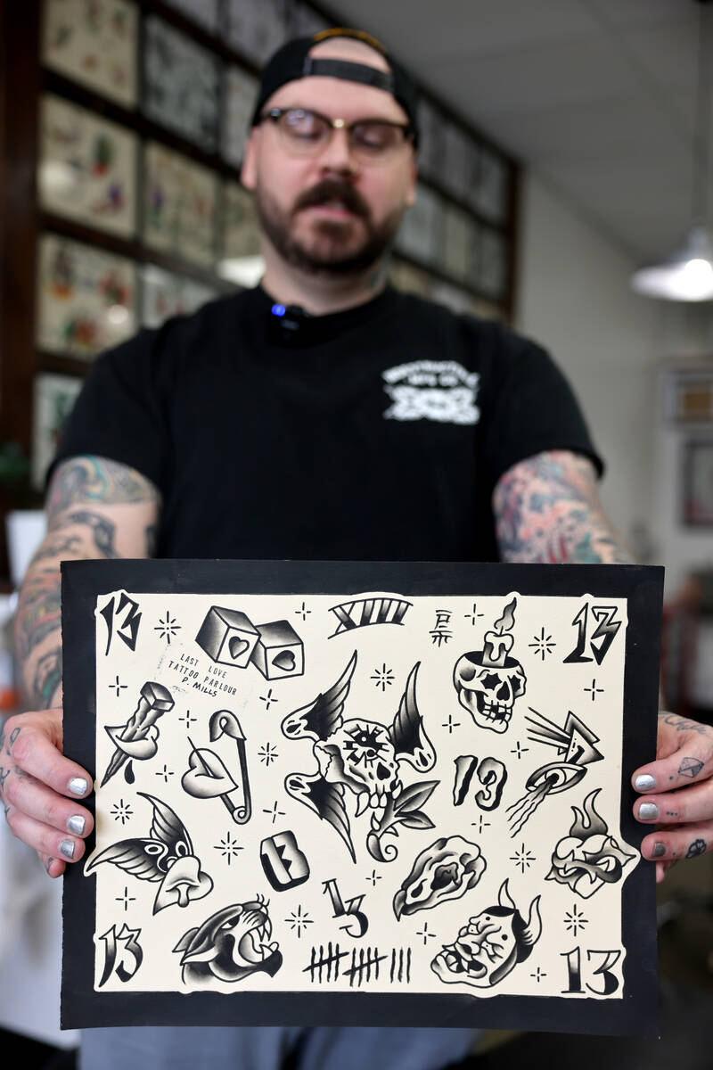 Pete Mills, who calls himself a tattooer, shows some of his flash available for the shop&#x2019 ...