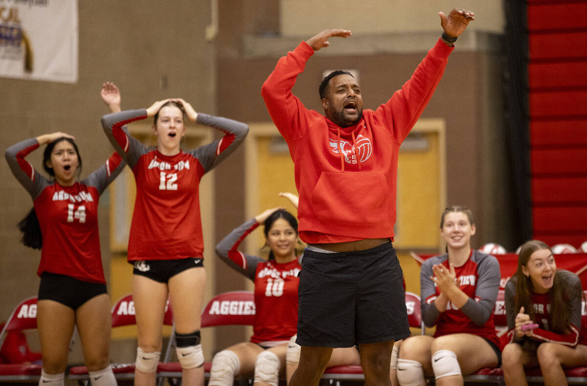 Arbor View Head Coach Josh Baugus and the bench celebrate a point during the high school volley ...