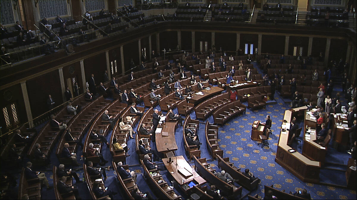 In this image from video, members of the House practice social distancing as they sit on the fl ...