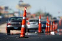 Orange cones blocking long segments of traffic lanes are usually protecting drivers and pedestr ...