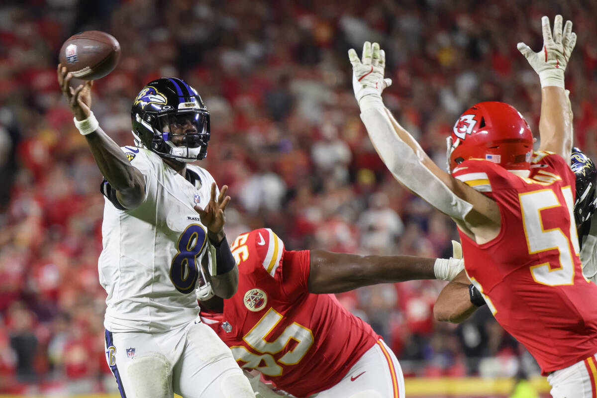 Baltimore Ravens quarterback Lamar Jackson (8) throws while being pressured by Kansas City Chie ...