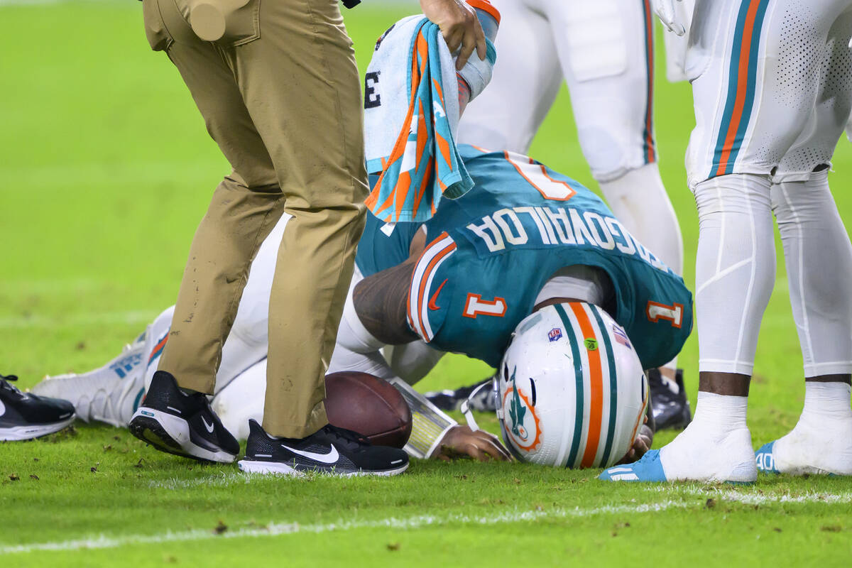 Miami Dolphins quarterback Tua Tagovailoa (1) kneels on the field after suffering an injury dur ...