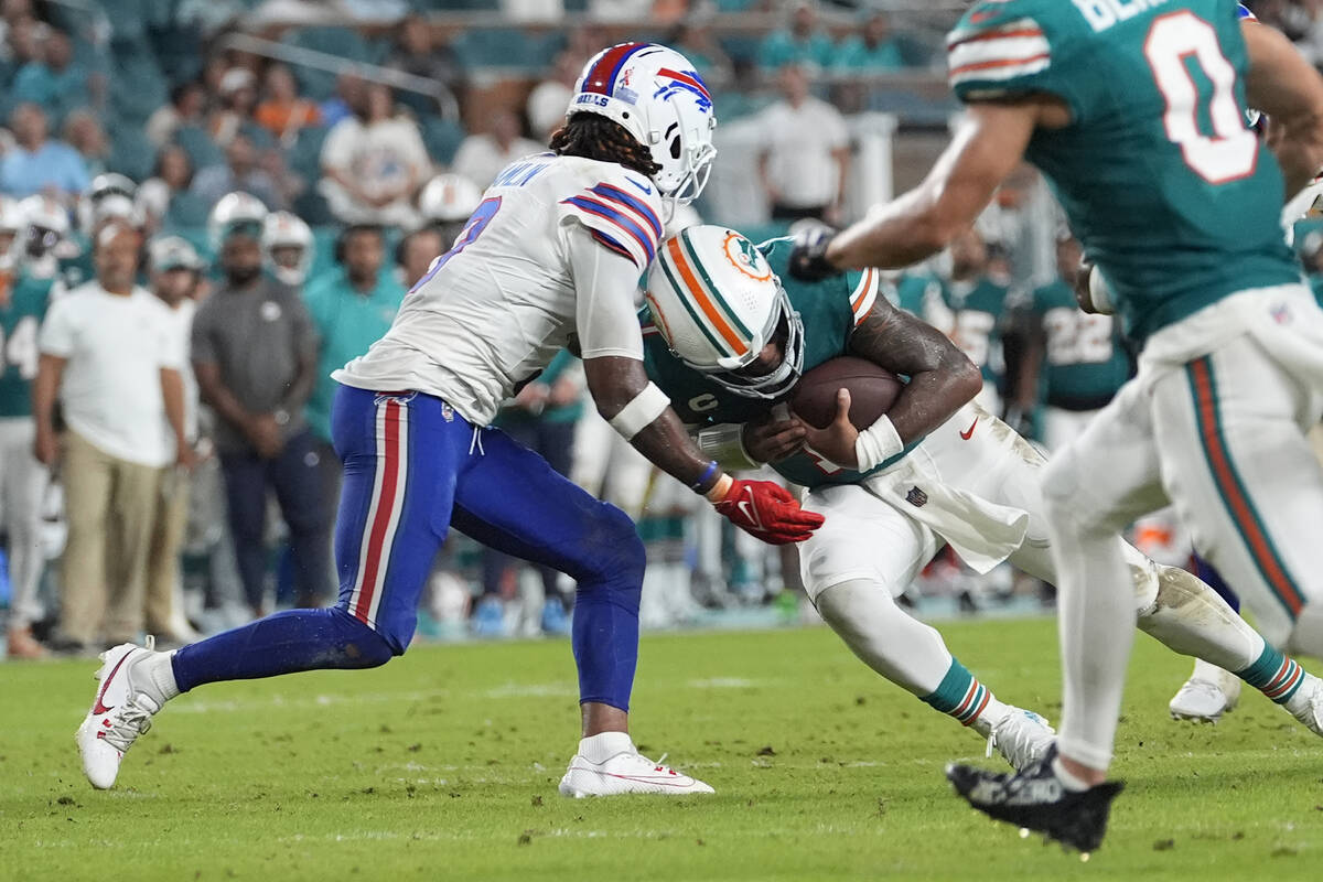 Miami Dolphins quarterback Tua Tagovailoa (1) and Buffalo Bills safety Damar Hamlin (3) collide ...