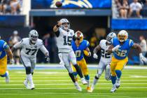 Raiders quarterback Gardner Minshew (15) gets off a pass as Los Angeles Chargers linebacker Kha ...