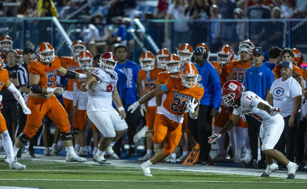 Bishop Gorman running back Jonathan Coar (21) cuts up field to evade Orange Lutheran defensive ...