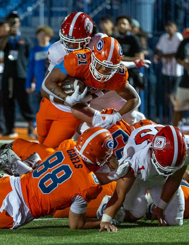 Bishop Gorman running back Jonathan Coar (21) battles for yards near the end zone against Orang ...