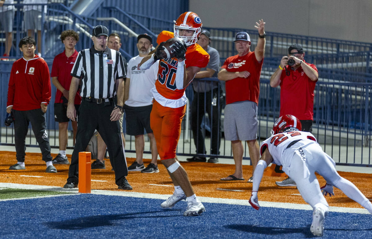 Bishop Gorman wide receiver Derek Meadows (30) secures a touchdown pass as Orange Lutheran corn ...