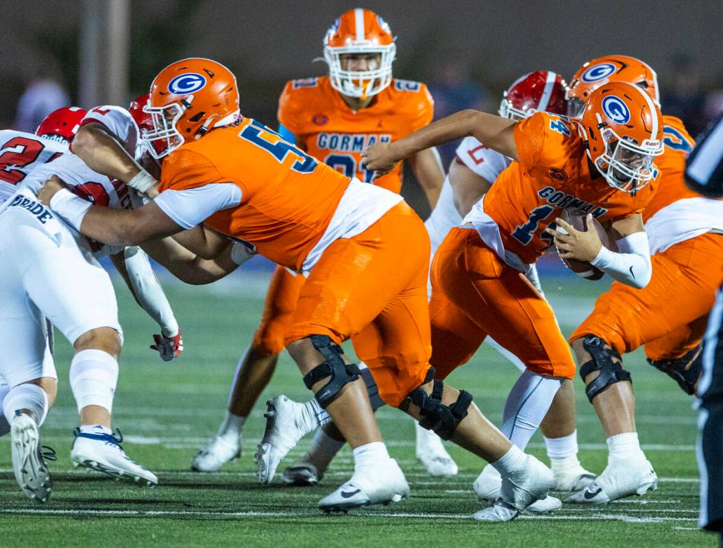 Bishop Gorman quarterback Maika Eugenio (14) breaks through the line on a run against Orange Lu ...